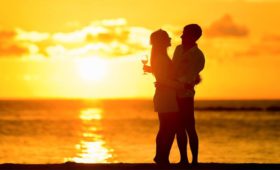 couple standing on beach in maldives